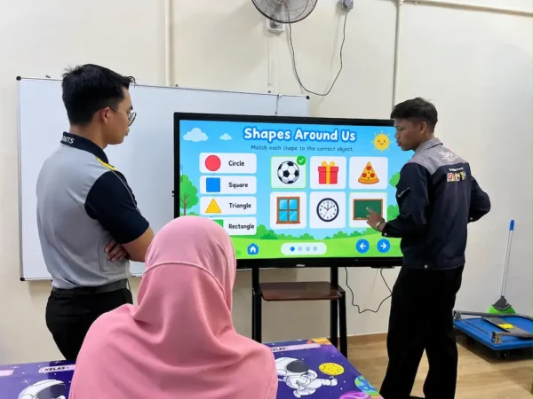 Arvia team demonstrating over 20 touchpoints on the AI smartboard for special education at SK PPKI Taiping