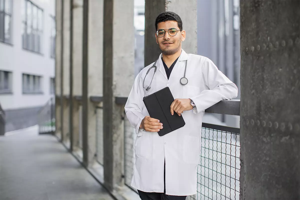 male indian arab doctor standing outdoors 1200x800 1